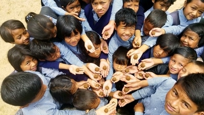 Students hold seed balls during the launch of a ‘Seed Ball Initiative’ as part of the World Environment Day celebrations, at Harding Theological College, Tura, in West Garo Hills of Meghalaya. 