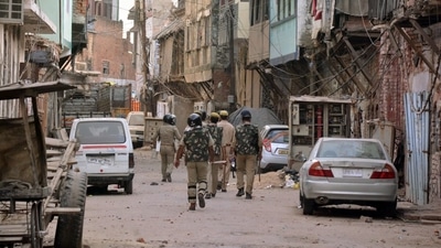 Police personnel patrolling after a communal clash broke out, in Kanpur in Uttar Pradesh on Friday. (ANI)