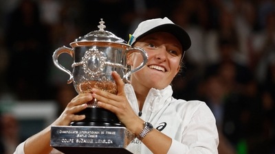 Poland's Iga Swiatek celebrtes with trophy after winning the women's singles final match against Cori Gauff of the U.S (REUTERS)