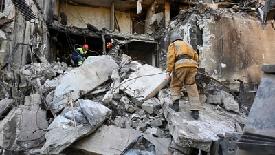 Rescuers dismantle the ruins of a residential building partially destroyed by shelling on the northern outskirts of second largest Ukrainian city of Kharkiv. (AFP) Rescuers dismantle the ruins of a residential building partially destroyed by shelling on the northern outskirts of second largest Ukrainian city of Kharkiv. (AFP)