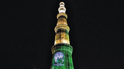 Qutub Minar illuminated on the eve of World Environment Day. (Amal KS/HT)