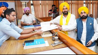 Punjab chief minister Bhagwant Mann accompanied his confidant and AAP candidate Gurmail Singh, 38, as he submitted his papers before the returning officer in Sangrur on Saturday. (HT Photo)