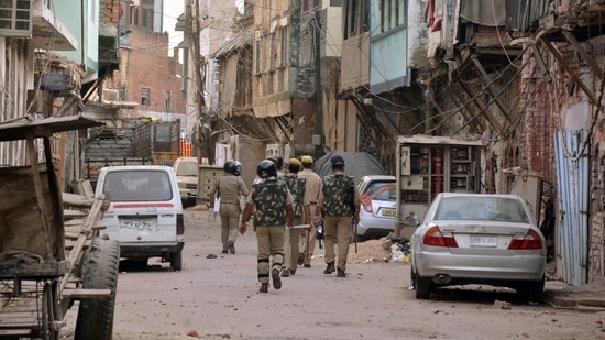 Police personnel patrolling after a communal clash broke out, in Kanpur in Uttar Pradesh on Friday. (ANI Photo)(Arshad Khan)