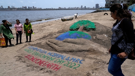 People look at a sand art made for World Environment day in Mumbai.(AP)