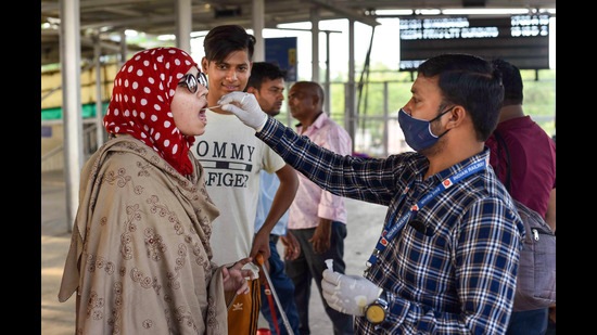 A health care worker collects a swab sample from a passenger for Covid-19 testing, Prayagraj, May 10, 2022 (PTI)