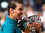 Rafael Nadal bites the trophy after winning the French Open 2022. Rafael Nadal bites the trophy after winning the French Open 2022.