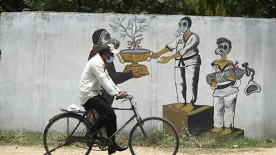 An elderly man rides past a graffiti to raise awareness on the environment, in Gurugram, India, on Sunday. (Parveen Kumar/HT PHOTO) An elderly man rides past a graffiti to raise awareness on the environment, in Gurugram, India, on Sunday. (Parveen Kumar/HT PHOTO)