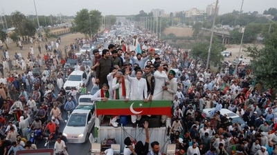 Ousted Pakistani Prime Minister Imran Khan gestures as he travels on a vehicle to lead a protest march in Islamabad, Pakistan. (Reuters)