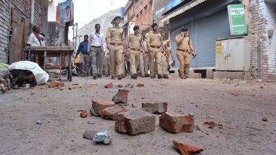 Police conduct a flag march in a locality after clashes broke out between two groups over market shutdown in Kanpur. (PTI) Police conduct a flag march in a locality after clashes broke out between two groups over market shutdown in Kanpur. (PTI)