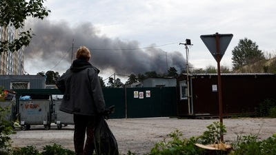 A man looks at the smoke after explosions were heard as Russia's attacks on Ukraine continues, in Kyiv. (Reuters)