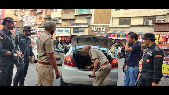 Police and paramilitary force checking a vehicle at Chaura Bazaar in Ludhiana on Sunday on the eve of the anniversary of Operation Bluestar. (Harvinder Singh/HT)