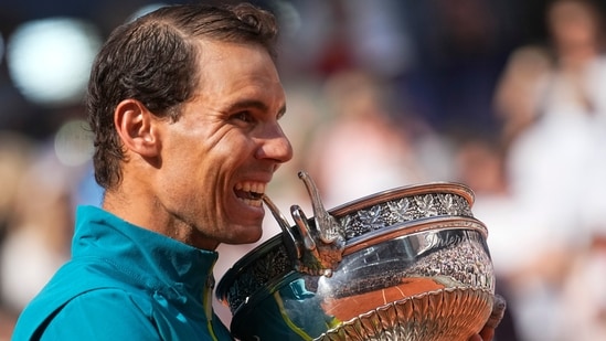Rafael Nadal bites the trophy after winning the French Open 2022.(AP)