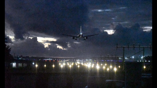 An aircraft lands amid dense clouds during monsoon season, at the Thiruvananthapuram International Airport, on June 1. (PTI)