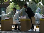 Residents get swabbed for mass Covid test in Beijing.