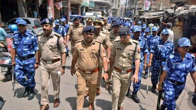 Police and Rapid Action Force (RAF) personnel patrol the Parade Chauraha area after violence broke out between two groups, in Kanpur on Monday. (ANI) Police and Rapid Action Force (RAF) personnel patrol the Parade Chauraha area after violence broke out between two groups, in Kanpur on Monday. (ANI)