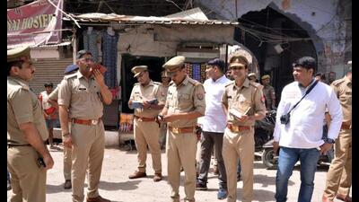 Police personnel stand guard at the Parade Chauraha area for the fourth consecutive day after violence broke out between two groups on June 3rd, in Kanpur on Monday. (ANI Photo)
