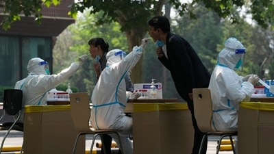 Residents get swabbed for mass Covid test in Beijing. (AP)