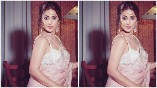 Hina’s organza saree featured minimal details in silver zari and moti. She paired it with a sleeveless white embellished white corset blouse.(Instagram/@realhinakhan)