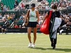 Britain's Emma Raducanu walks off as she retires from her first round match against Switzerland's Viktorija Golubic