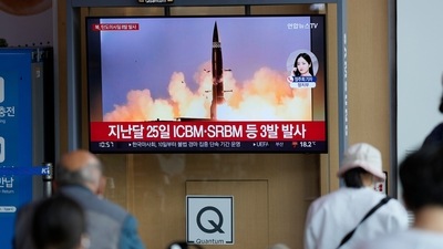 People watch a TV screen showing a news program reporting about North Korea's missile launch. (AP)