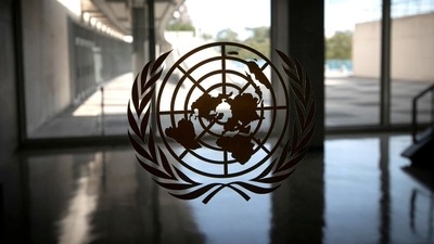 The United Nations logo is seen on a window in an empty hallway at United Nations headquarters. (REUTERS)