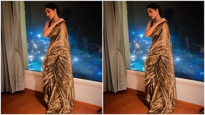 The six yards features metallic zari selvedge all around the borders and crumpled fabric texture. Sobhita teamed it with a printed black blouse adorned with golden embroidered stripes, a plunging neckline, bare back detail, and a cropped hem flaunting her midriff. (Instagram)