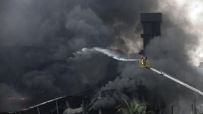 Bangladeshi firefighters work to put out a huge fire at the site of an explosion in a factory (AFP)