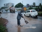Volunteers try to remove water logging in potholes at a busy road after heavy rain in Kochi. (AP file) Volunteers try to remove water logging in potholes at a busy road after heavy rain in Kochi. (AP file)