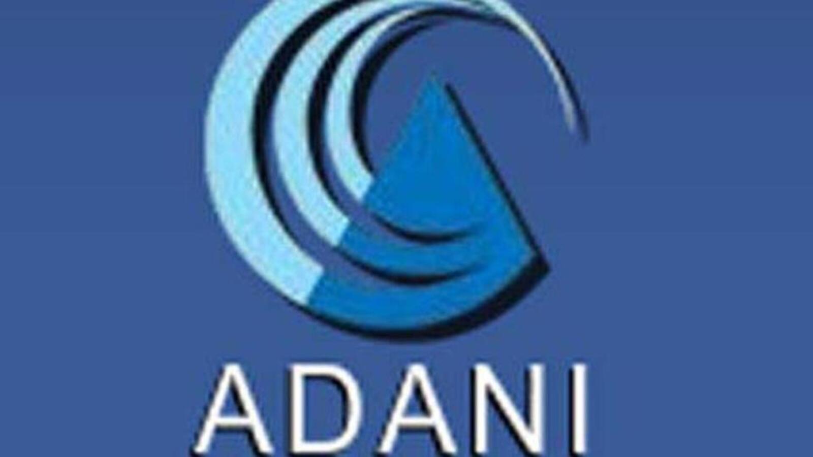 People are seen working on a truck next to the Adani logo on a poster...  News Photo - Getty Images