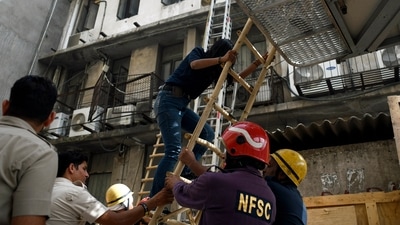 Firemen conduct rescue operations after a fire broke out at the basement's meter board in Lajpat Nagar area, in New Delhi on Wednesday. (ANI Photo)