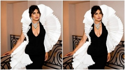 Priyanka decked up in a black bodycon backless gown with a plunging neckline and dramatic frills in white bordering her shape. The frills also featured around her neck giving us the vibes of a halo. (Instagram/@priyankachopra)