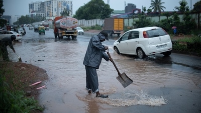 Volunteers try to remove water logging in potholes at a busy road after heavy rain in Kochi. (AP file) Volunteers try to remove water logging in potholes at a busy road after heavy rain in Kochi. (AP file)