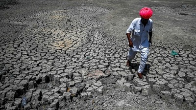 A villager walking through the cracked bottom of a dried-out pond at Bandai village in Pali district, Rajasthan. (AFP file) A villager walking through the cracked bottom of a dried-out pond at Bandai village in Pali district, Rajasthan. (AFP file)