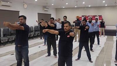 Workers practising yoga at the event held by ESIC in Ludhiana. (HT PHOTO)