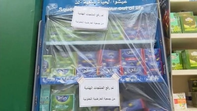 Workers of Al Ardiya Co operative Society, a superstore in Kuwait City, are seen bringing down Indian teas and other products from their shelves. Workers of Al Ardiya Co operative Society, a superstore in Kuwait City, are seen bringing down Indian teas and other products from their shelves.