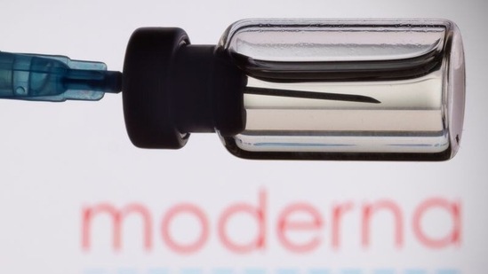 A vial and a syringe are seen in front of a displayed Moderna logo. (Representational image)(REUTERS)