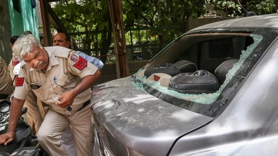 New Delhi: Policemen inspect the spot after stone pelting incident at Jahangirpuri area in New Delhi, Wednesday, June 8, 2022. (PTI Photo)