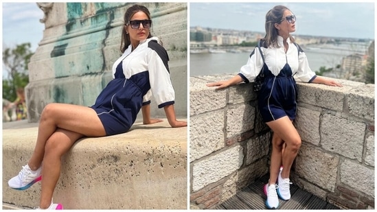 Hina wore a mini playsuit for her day outing in Budapest. It comes in blue, white and black shades and is from the shelves of the sustainable clothing label Sunandini. She championed colour block fashion in the ensemble.(Instagram/@realhinakhan)