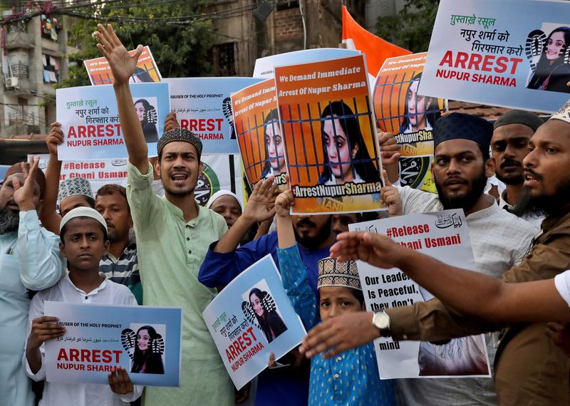People shout slogans as they hold placards during a protest demanding the arrest of Nupur Sharma for her comments on Prophet Mohammed. (Reuters) People shout slogans as they hold placards during a protest demanding the arrest of Nupur Sharma for her comments on Prophet Mohammed. (Reuters)