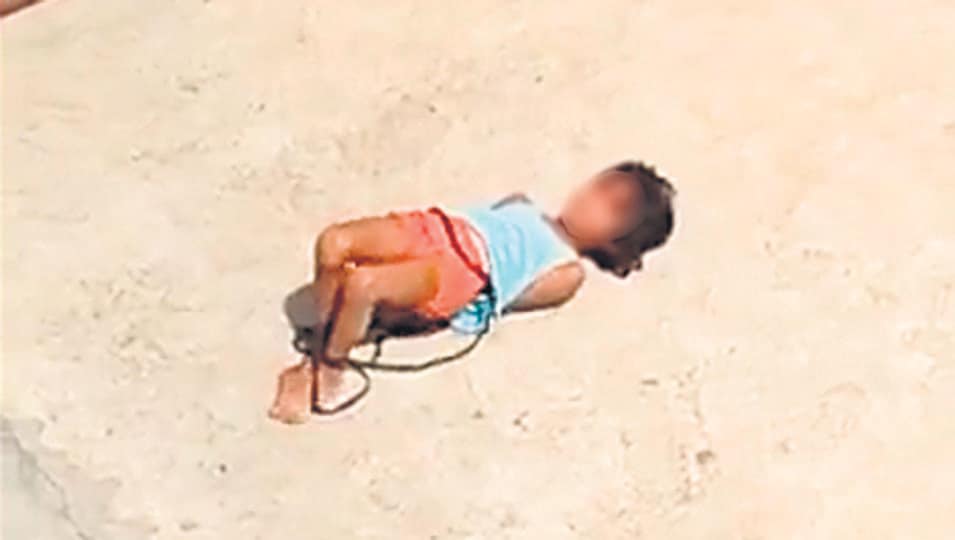 A video grab shows the girl, her hands and legs tied, on the terrace of her home in northeast Delhi’s Khajuri Khas. (Sourced) A video grab shows the girl, her hands and legs tied, on the terrace of her home in northeast Delhi’s Khajuri Khas. (Sourced)