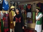 FILE - Ajmal Haqiqi, right, watches as Mahal Wak, center, practices modeling, in Kabul, Afghanistan, Aug. 3, 2017. The Taliban have detained a famous Afghan fashion model along with three colleagues, including Haqiqi, accusing them of disrespecting Islam and the Holy Quran. FILE - Ajmal Haqiqi, right, watches as Mahal Wak, center, practices modeling, in Kabul, Afghanistan, Aug. 3, 2017. The Taliban have detained a famous Afghan fashion model along with three colleagues, including Haqiqi, accusing them of disrespecting Islam and the Holy Quran. 