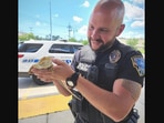 The picture shows the policeman with the rescued animal that people though was an iguana.