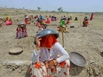 Labourers under MNREGA use mortar pans to protect themselves against the scorching sun, at a worksite on the outskirts of Beawar, Rajasthan. (PTI file photo) Labourers under MNREGA use mortar pans to protect themselves against the scorching sun, at a worksite on the outskirts of Beawar, Rajasthan. (PTI file photo)