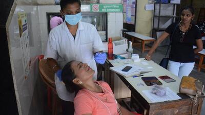 A health worker collects swab samples of a citizen for Covid-19 test at TMC's CR Wadia Hospital in Thane on Thursday (HT Photo/Praful Gangurde) A health worker collects swab samples of a citizen for Covid-19 test at TMC's CR Wadia Hospital in Thane on Thursday (HT Photo/Praful Gangurde)