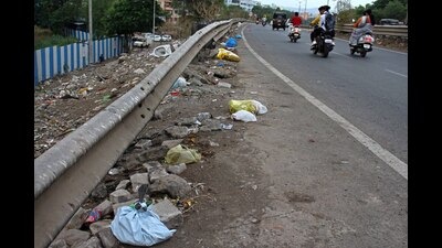Garbage lying on new Dehu road - Bengaluru road near Narhe. (Ravindra Joshi/HT PHOTO)