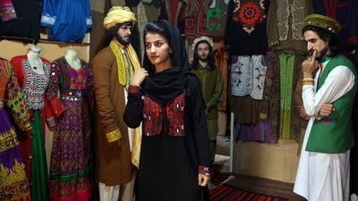 FILE - Ajmal Haqiqi, right, watches as Mahal Wak, center, practices modeling, in Kabul, Afghanistan, Aug. 3, 2017. The Taliban have detained a famous Afghan fashion model along with three colleagues, including Haqiqi, accusing them of disrespecting Islam and the Holy Quran. (AP) FILE - Ajmal Haqiqi, right, watches as Mahal Wak, center, practices modeling, in Kabul, Afghanistan, Aug. 3, 2017. The Taliban have detained a famous Afghan fashion model along with three colleagues, including Haqiqi, accusing them of disrespecting Islam and the Holy Quran. (AP)