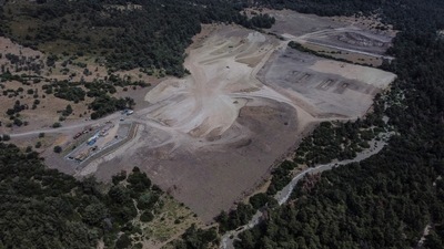 In this aerial view taken on June 6, 2022 in the outskirts of a dense pine forest of the island of Lesbos, construction is underway on a new migrant camp for 3,000 people over the objections of many local residents. (AFP) In this aerial view taken on June 6, 2022 in the outskirts of a dense pine forest of the island of Lesbos, construction is underway on a new migrant camp for 3,000 people over the objections of many local residents. (AFP)