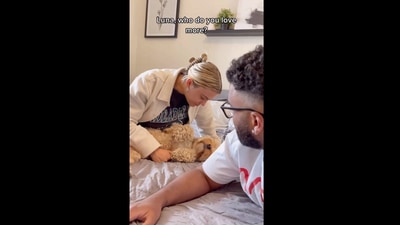 The image, taken from the viral Instagram video, shows the dog with her pet parents. (Instagram/@lunatheminicockapoo)