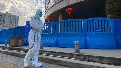 A worker in protectively overalls and carrying disinfecting equipment walks outside the Wuhan Central Hospital, China. (File image) (AP) A worker in protectively overalls and carrying disinfecting equipment walks outside the Wuhan Central Hospital, China. (File image) (AP)