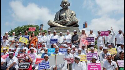 Karnataka Congress leaders stage a protest against the textbook row, in front of the Gandhi statue at Vidhana Soudha in Bengaluru on Thursday. (ANI) Karnataka Congress leaders stage a protest against the textbook row, in front of the Gandhi statue at Vidhana Soudha in Bengaluru on Thursday. (ANI)